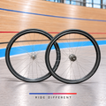 700c single speed clincher wheelset – front and rear wheels on velodrome background