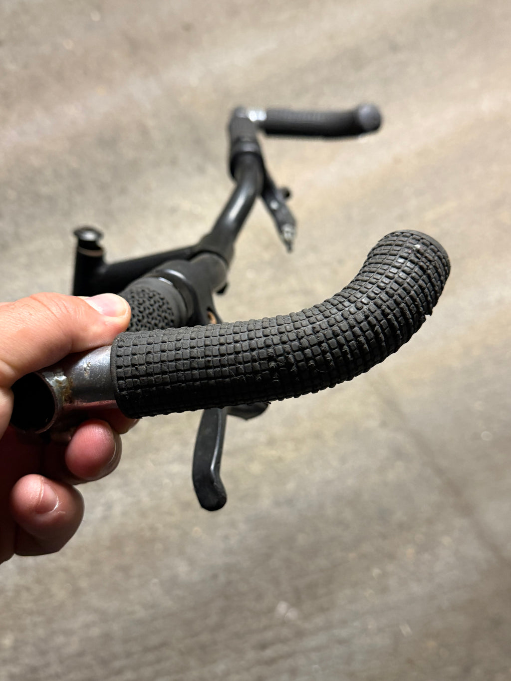 Textured rubber grip on black MTB handlebar