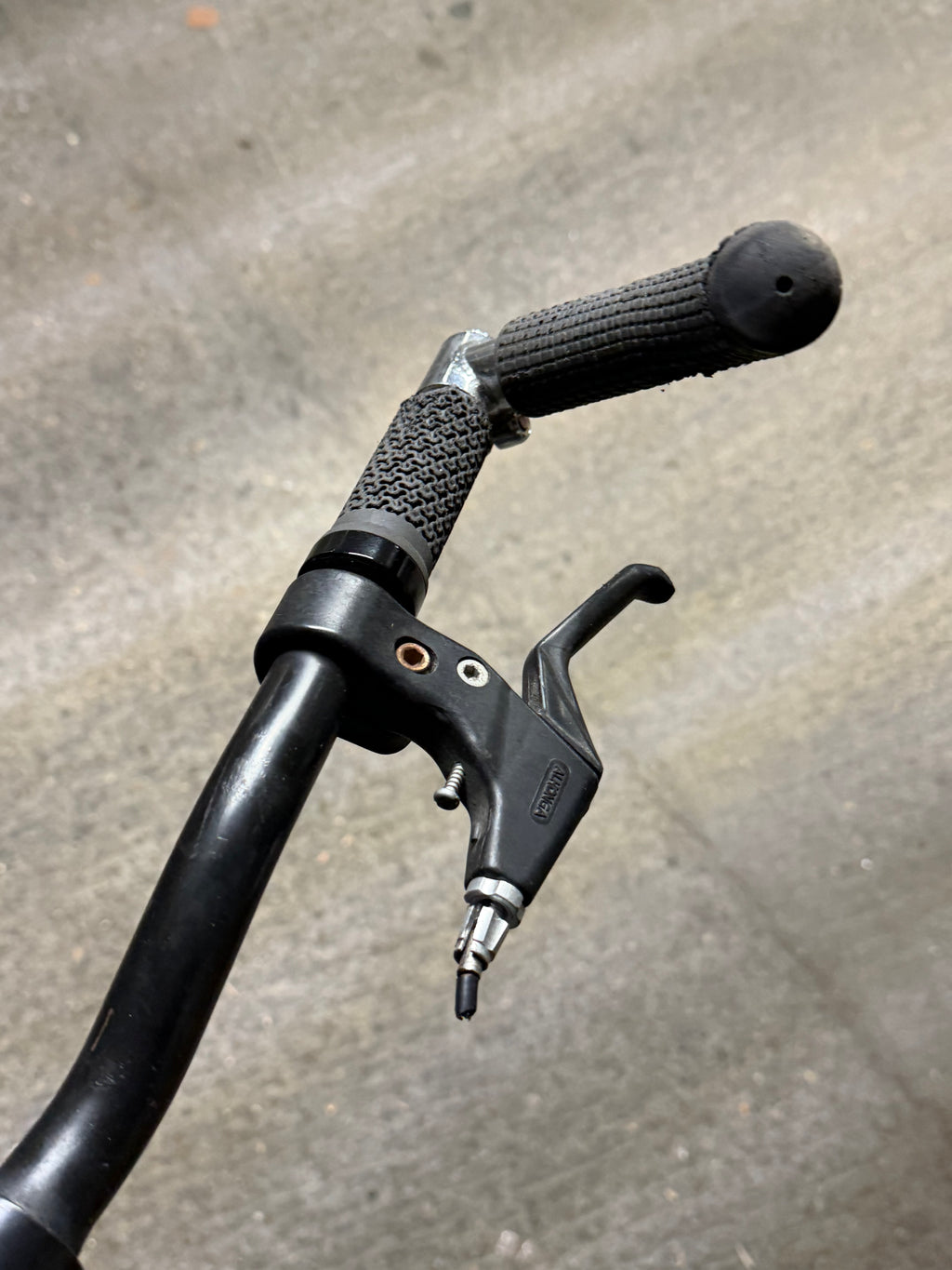Close-up of black handlebar grip and brake lever
