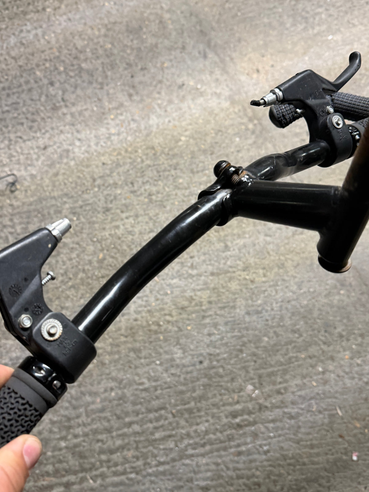 Angled view of black handlebars and quill stem