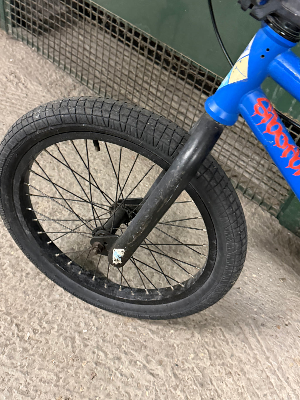 Front wheel and black fork of blue Sunday BMX