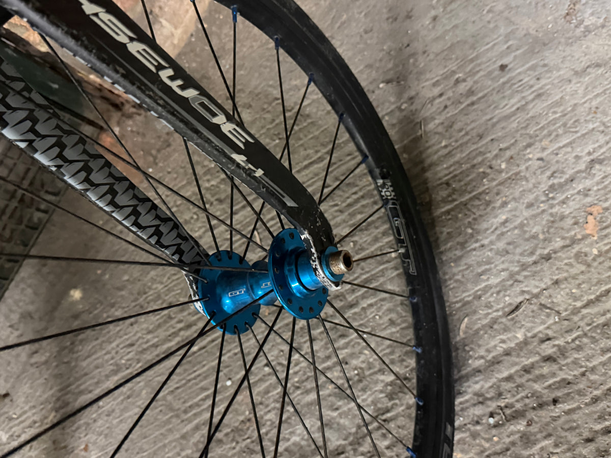 Close-up of carbon fork and blue front hub