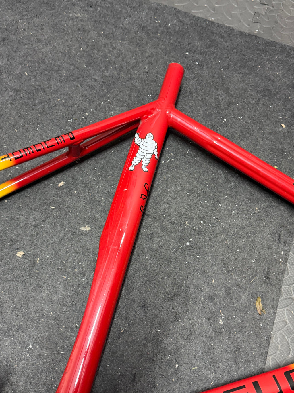 Custom red and yellow aluminium track frame – seat cluster and red seat tube