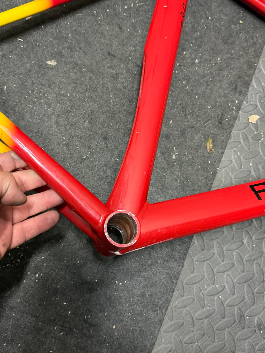 Custom red and yellow aluminium track frame – bottom bracket shell close-up