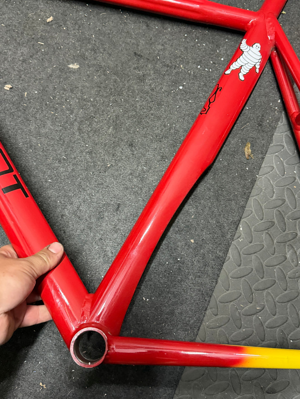 Custom red and yellow aluminium track frame – seat tube and bottom bracket area