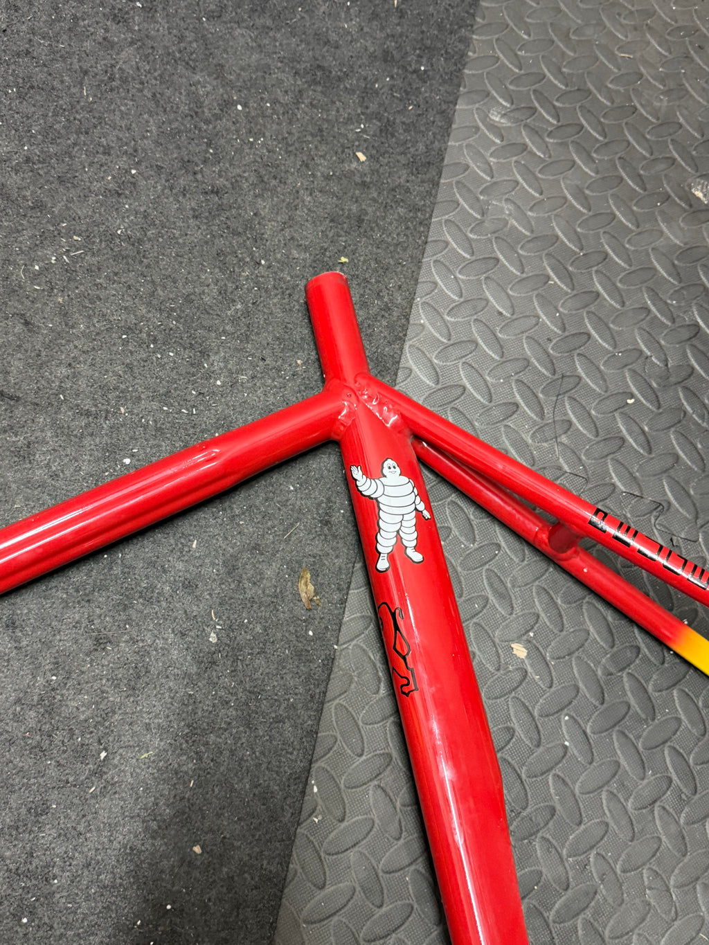 Custom red and yellow aluminium track frame – seat tube opening and seat stay junction