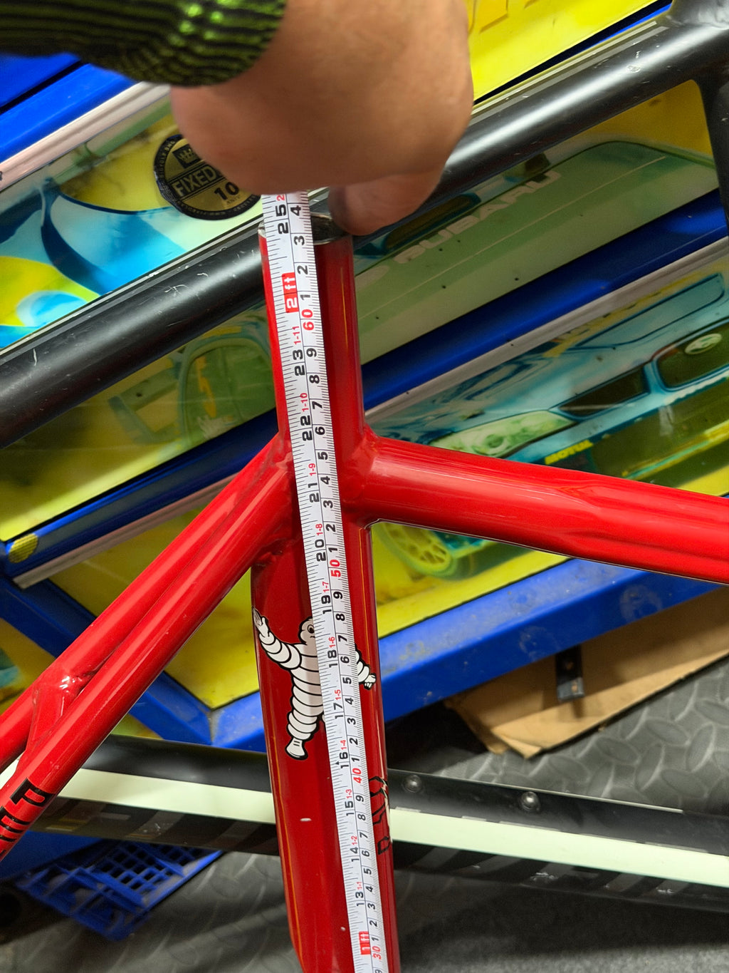 Custom red and yellow aluminium track frame – seat tube measurement with tape