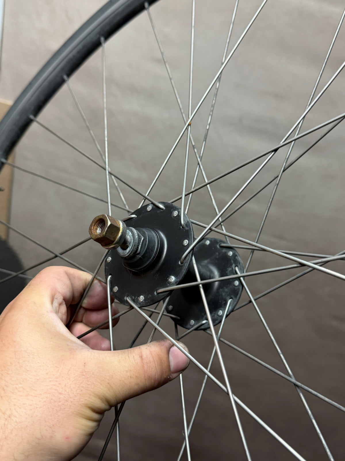 700c clincher track front wheel – front hub held close to camera