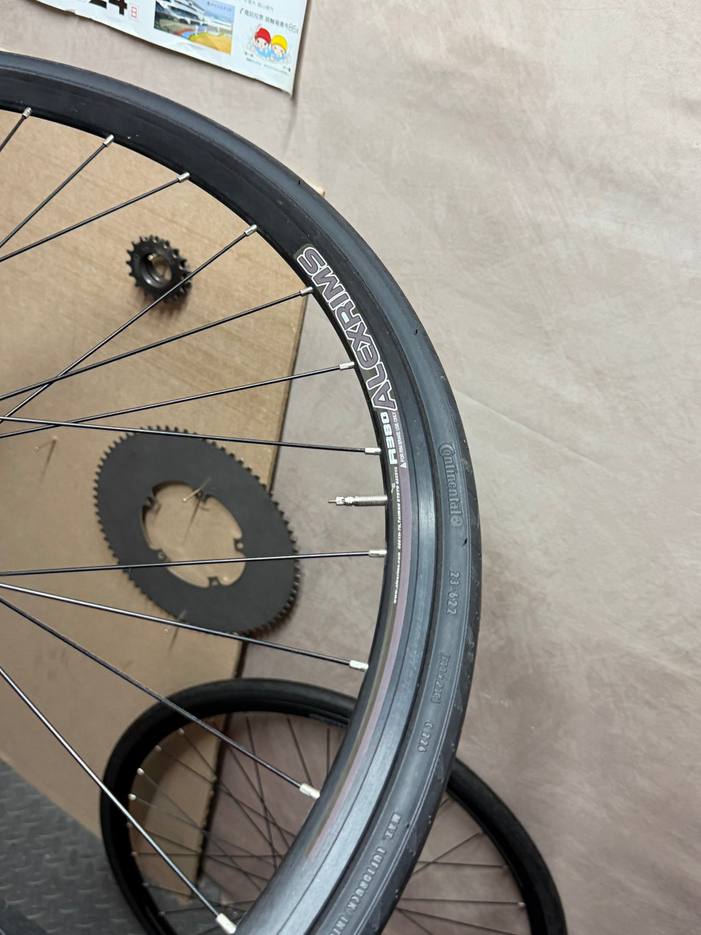 Alexrims 700c clincher track wheelset – rim and tyre with spare wheel behind